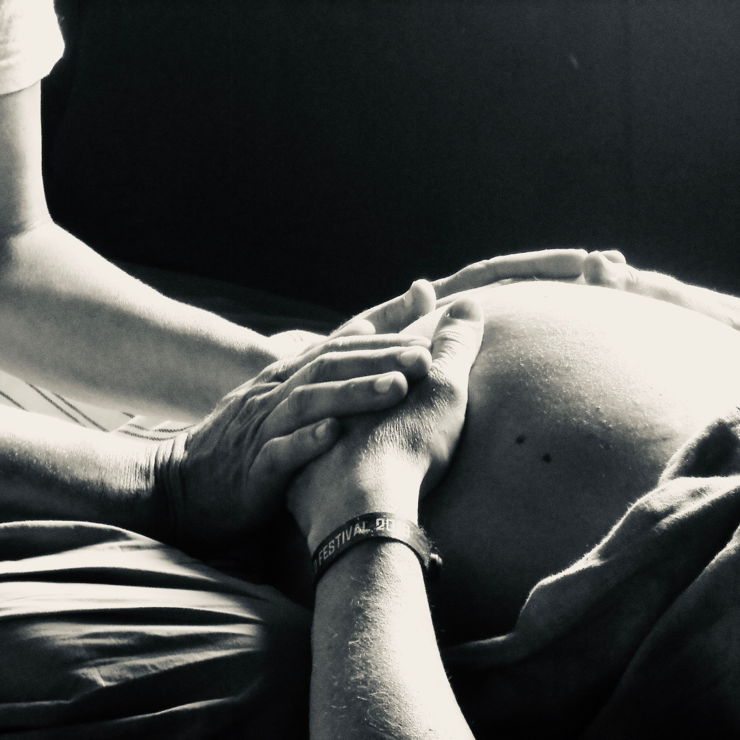 Hands on Baby Belly from a Birth Doula Helper